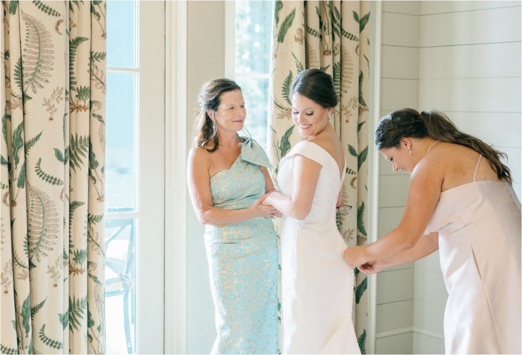bride and her mother and sister getting ready for lake keowee wedding day